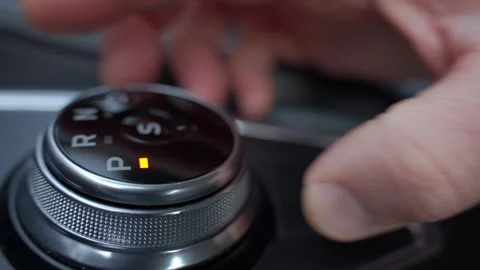 Driver hand turning automatic gear selector in car Video stock 326282147