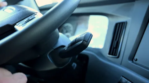 The driver hand turns on the gear shift in the truck. Stock-Footage 315722113