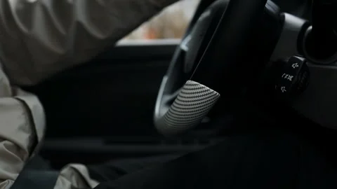 Driver hands holding steering wheel driving a modern car close up. Stock Footage 339580898