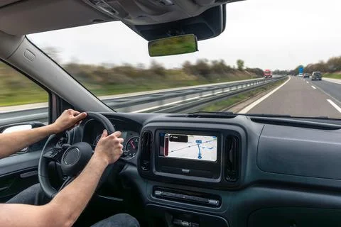 Driver Hands On Steering Wheel With Highway Navigation Stock Photos