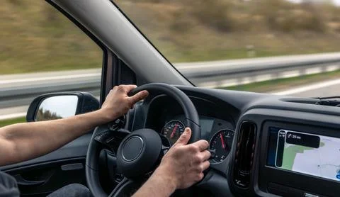 Driver Hands On Steering Wheel With Navigation Dashboard Stock Photos