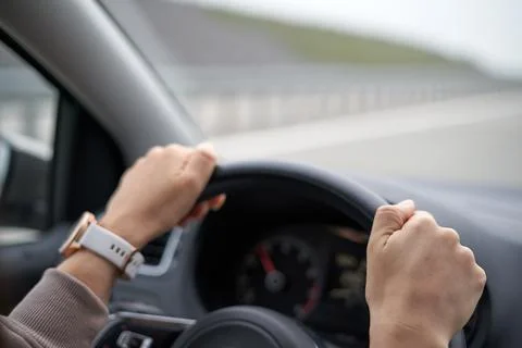 Driver hands on steering wheel Stock Photos