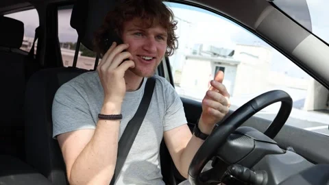 Driver hears great news during a phone call while driving Stock Footage 343719733