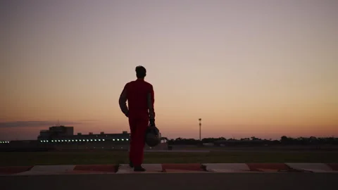 Driver with a Helmet looking at something at sunset Stock Footage 264375271