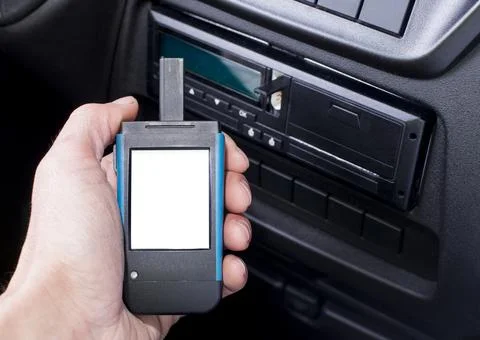 Driver holding a digital tachograph reader with isolated white screen Foto stock