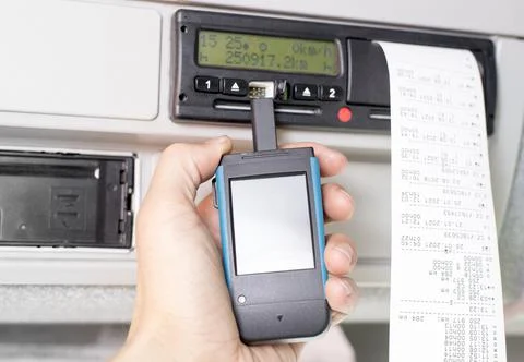 Driver holding a digital tachograph reader with isolated white screen Stock Photos