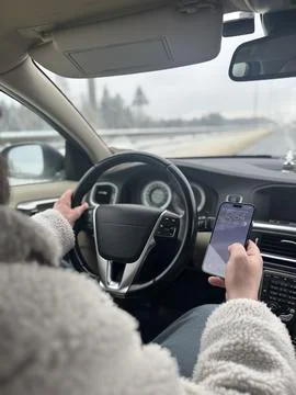 Driver Holding Phone While Operating Vehicle Stock Photos