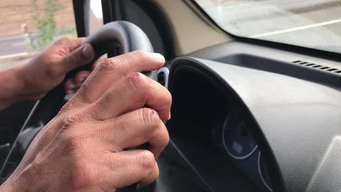 Driver holding steering wheel, multiple views Stock Photos