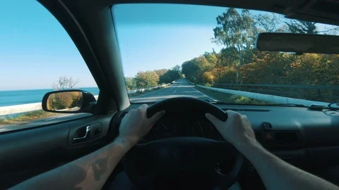 Driver holds both hands on steering wheel as he drives his car Stock Footage 98075982
