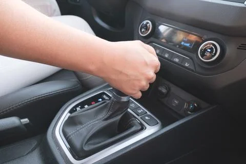 Driver holds on to the shift lever of the automatic transmission Stock Photos