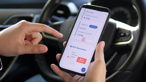 A driver inputs service details into a maintenance tracker app, emphasizing Stock Footage 315744468