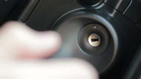 Driver inserting car ignition key Stock Footage 88299191