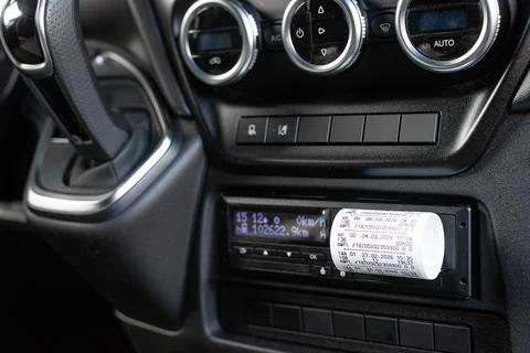 Driver inserting card into digital tachograph for log record Stock Photos