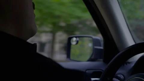 Driver inside a car, with focus on the window and side mirror reflecting... Stock Footage 319880973