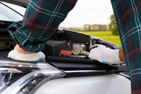 The driver inspects the engine compartment of the car Stock Photos