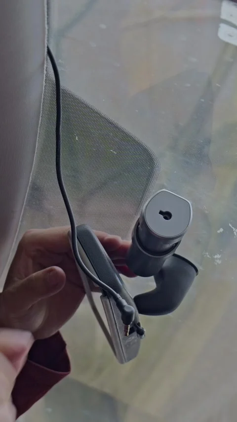 The driver installs a dash cam on the windshield. Stock Footage 329398070