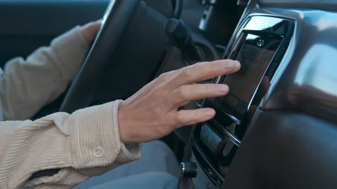 Driver interacting with car navigation system Stock Footage 334623709