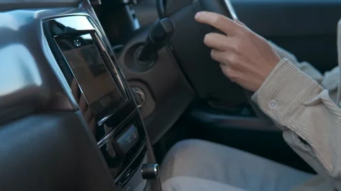 Driver interacting with car navigation system and steering wheel Stock Footage 344822687