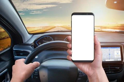 Driver keeps the phone while driving. Isolated screen for mockup. Modern car  Stock Photos