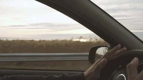 The driver knocks his fingers on the wheel Stock Footage 82970190