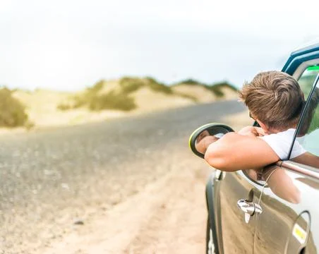 Driver leaning out of car window on roadside in Lanzarote Stock Photos