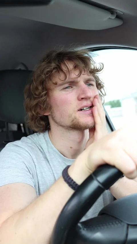 Driver listens closely to a repetitive knocking sound while the car is moving Stock Footage 342922485