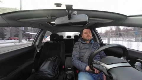 Driver looks at the road while he drive a car. Stock Footage 224121567