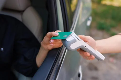 The driver makes contactless NFC payment with a credit card Stock Photos