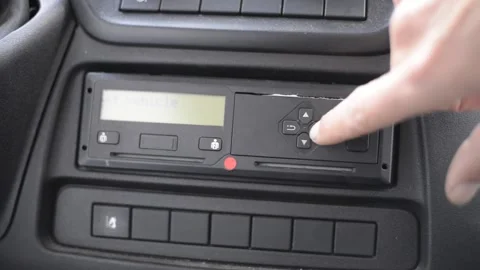 Driver makes a print of his day time shift on a digital tgachograph Stock Footage 168235175