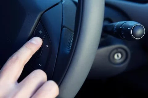 Driver Making Hands Free Call In Car With Button On Steering Wheel Stock Photos