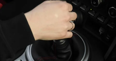 Driver man controls auto, switch gears and removes handbrake handle, closeup. Stock Footage 131231191