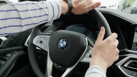 Driver man in new car touch and feel the steering wheel and steering panel with Stock Footage 141433385