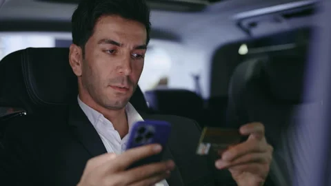 Driver Man Sitting in the Car, Using Smartphone for Online Shopping with Credit Stock Footage 264338452