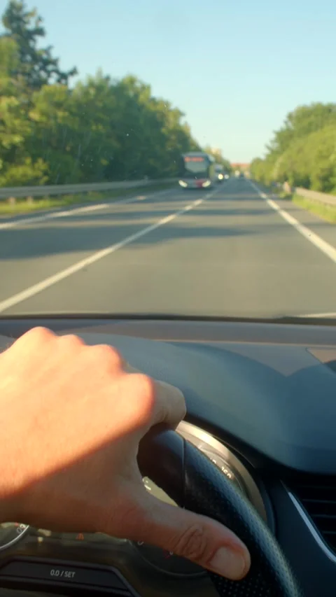 A driver navigates a scenic highway, showcasing control and comfort Stock Footage 314346280