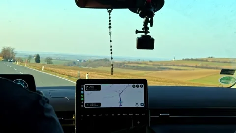 Driver navigating car on an open road, GPS screen showing route, traveling Stock-Footage 333722210