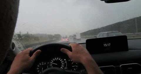 Driver navigating rainy road with windshield wipers Stock Footage 265239975