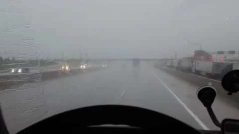 Driver navigating through a heavy rainstorm on a highway Stock Footage 281764245