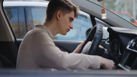 The driver is nervous because he can't start the car, rear view Stock Footage 296293081