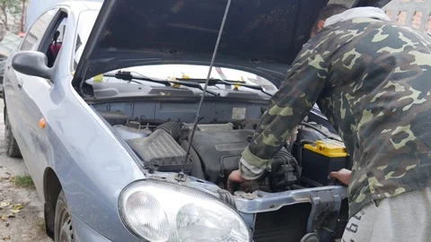 Driver open the hood and checking the oil level. Car care. Checking car engine Stock Footage 119465886