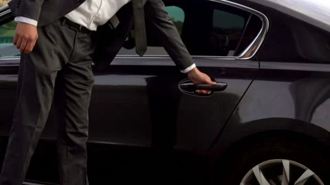 Driver is opening the car door for his client Stock Footage 108404666