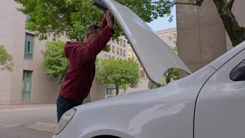 The driver opens the car hood. Stock Footage 329165410