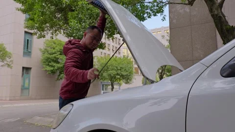 The driver opens the car hood. Stock Footage 329165581