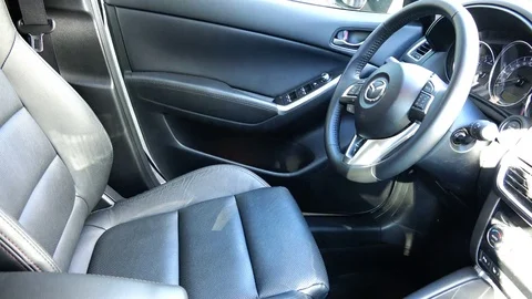 The driver opens the door and drives Mazda's car. Stock Footage 85374044