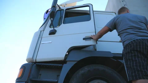 Driver opens the door and exits from parked truck. Lorry parked in countryside Stock Footage 305701266