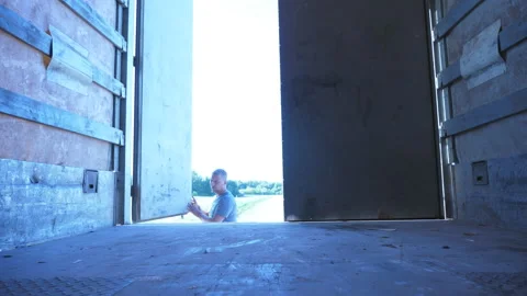 Driver opens the door of trailer at parked truck at summer sunny day. Stock Footage 95545424