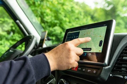 Driver operating car GPS navigation system 스톡 사진