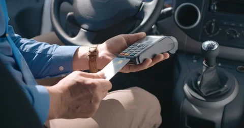 The driver pays for the service by inserting a card into the mobile terminal  Stock Footage 119538862