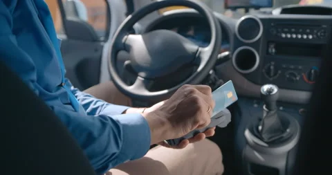 The driver pays for the service by rolling the card through the mobile terminal  Stock Footage 119538433