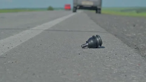 The driver picks up a spare part that is lying on the road Stock Footage 131648049