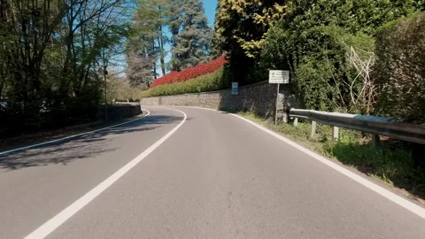 Driver point of view on empty road in northern Italy with distant mountains in Stock Footage 332808129